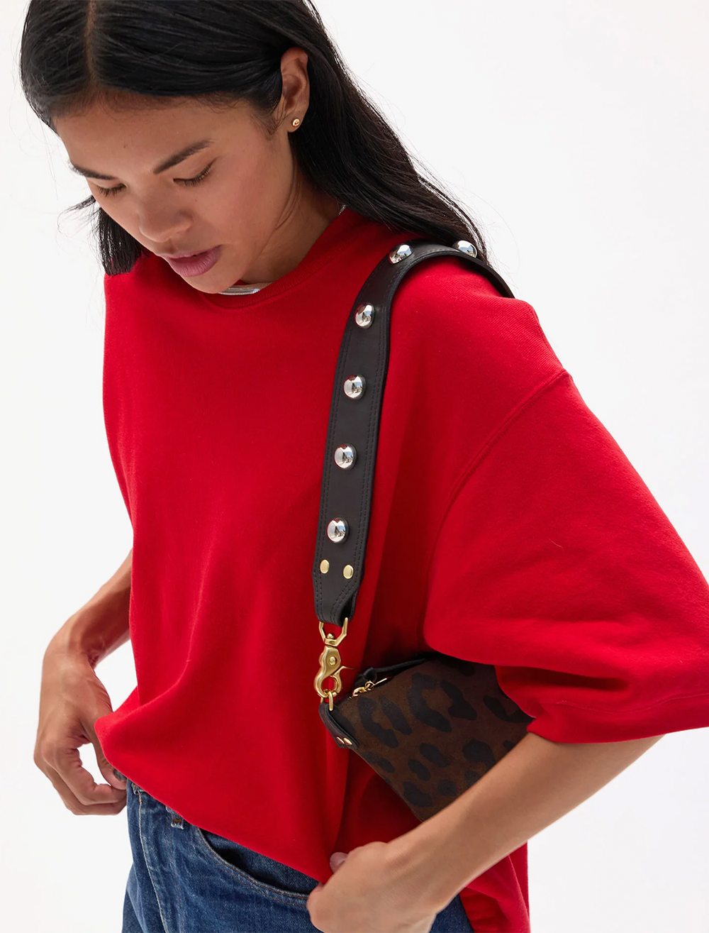 model using shoulder strap in black leather with studs