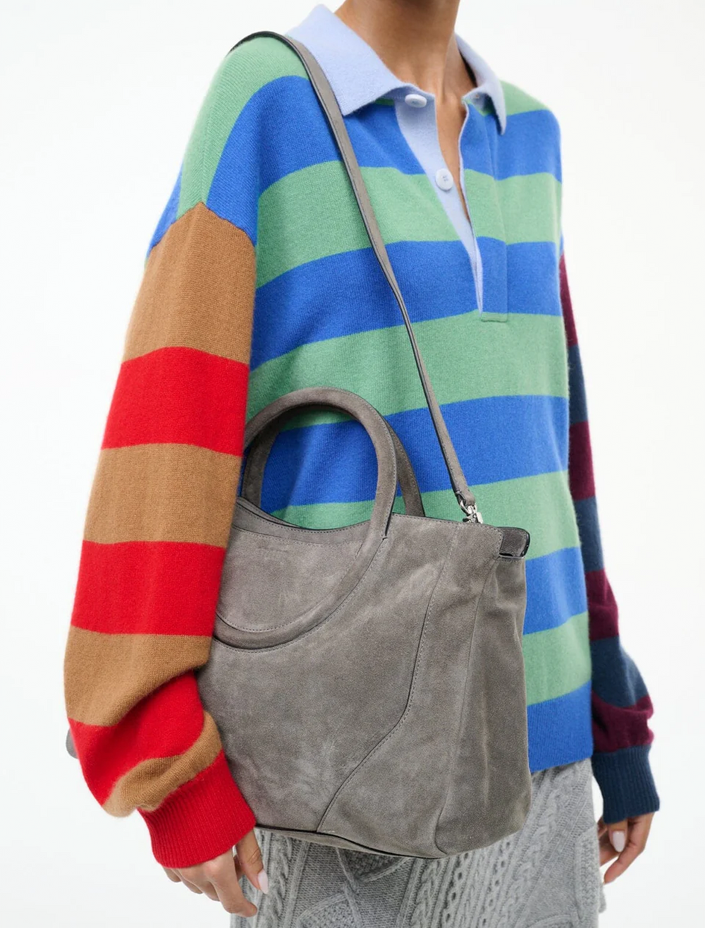 model holding maude satchel in storm