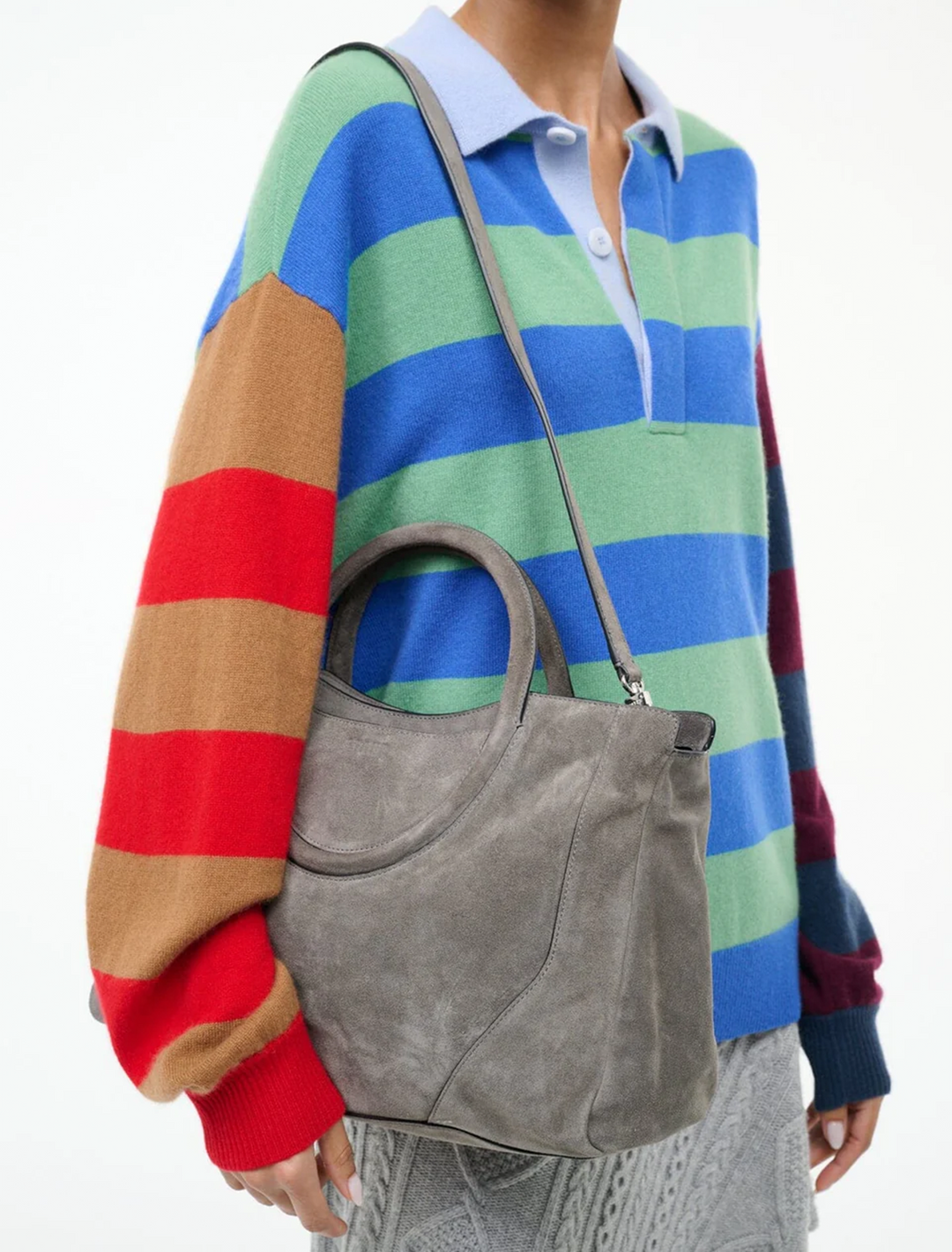 model holding maude satchel in storm