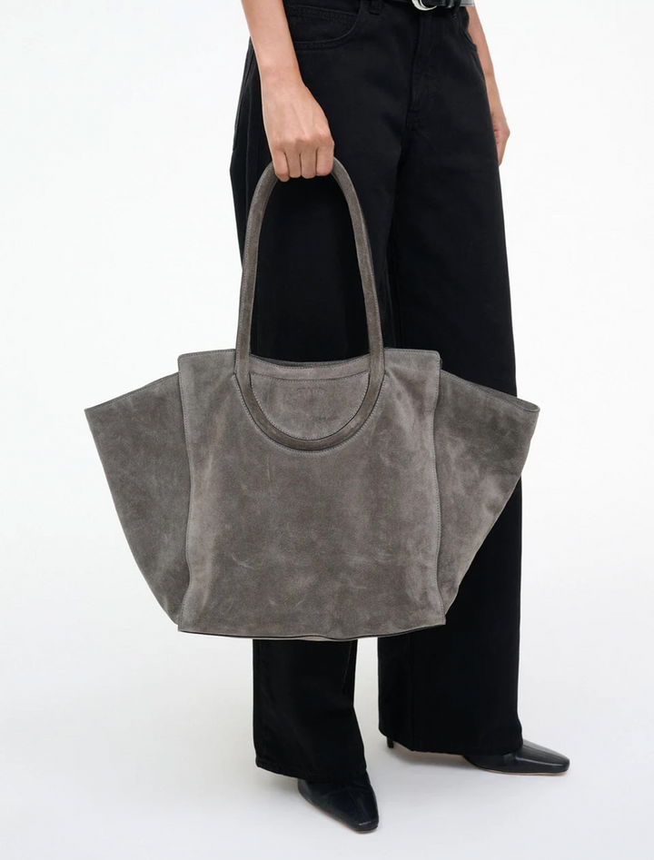 model holding maude tote bag in storm