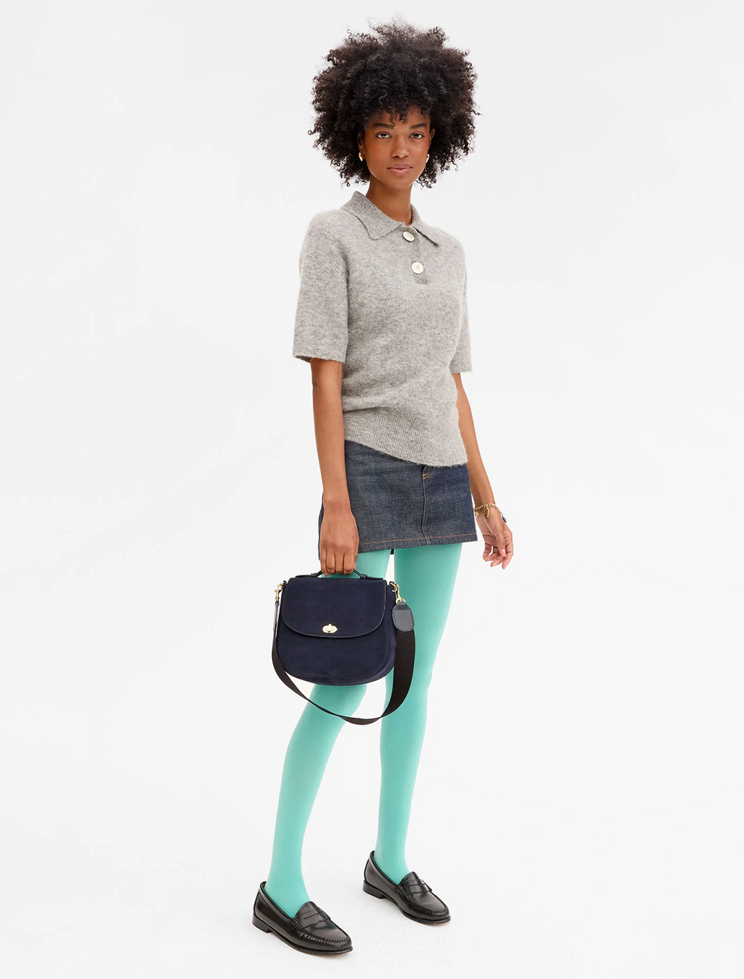 model holding turnlock louis in navy suede