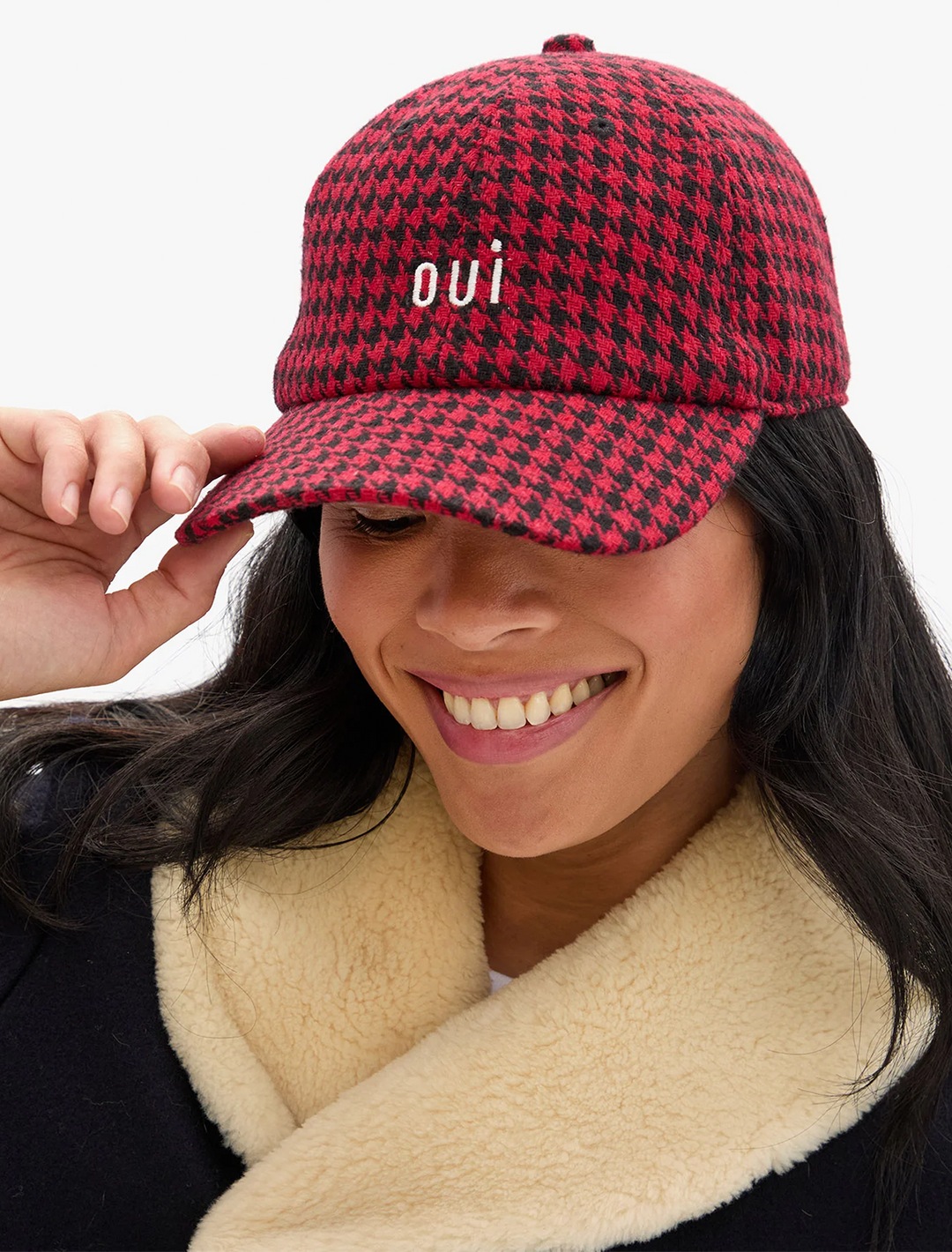 model wearing black and red wool oui baseball hat