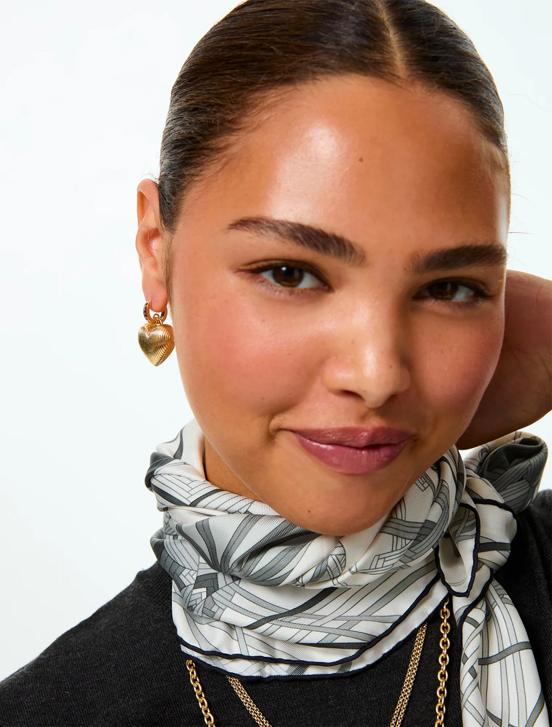 model wearing the mini florentine heart earrings