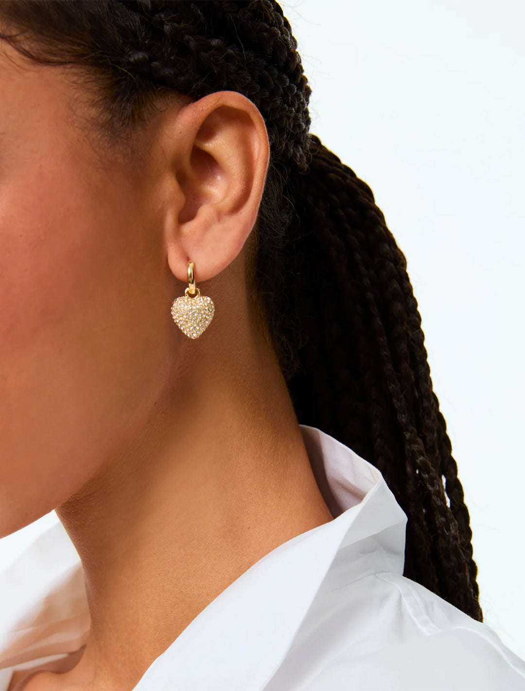 model wearing the pave puffy heart earrings