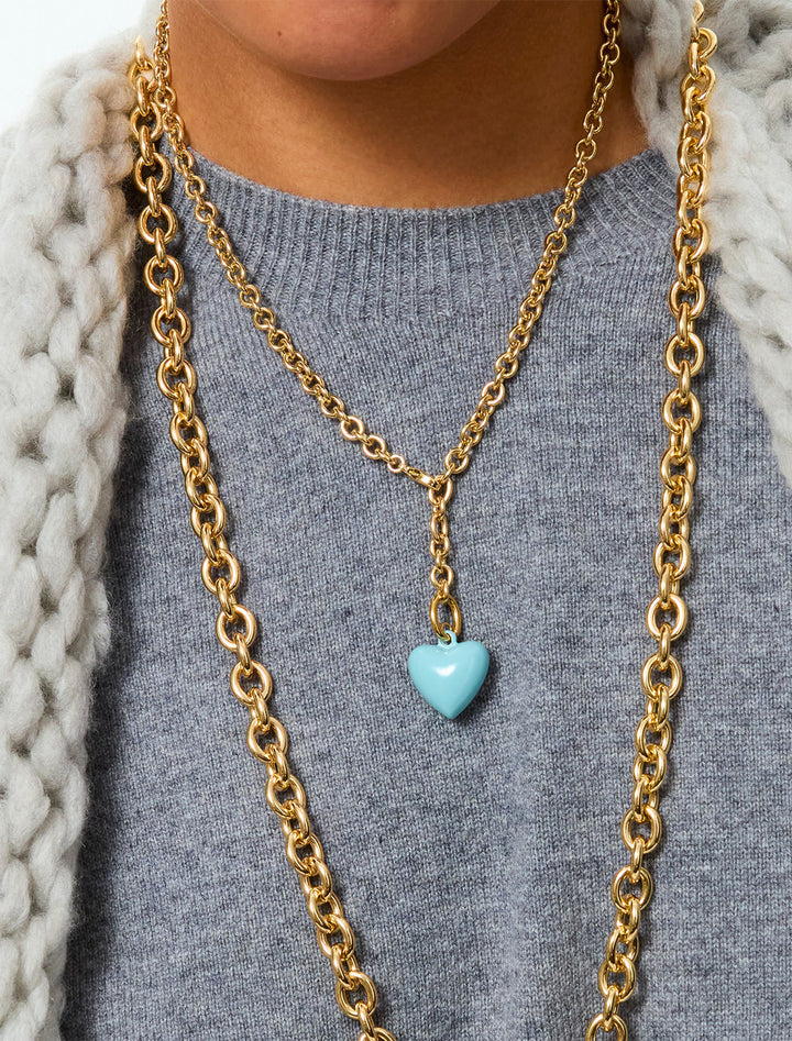 model wearing the mini puffy heart necklace in cloud