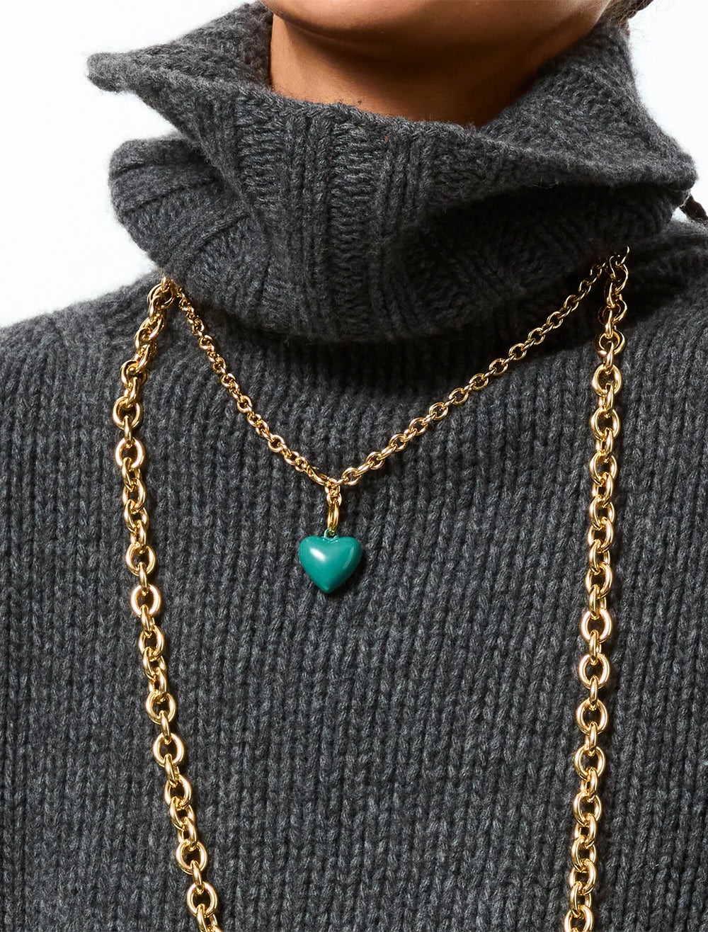 model wearing the mini puffy heart necklace in forest