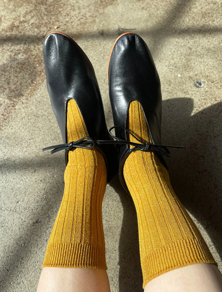 her socks in mustard glitter