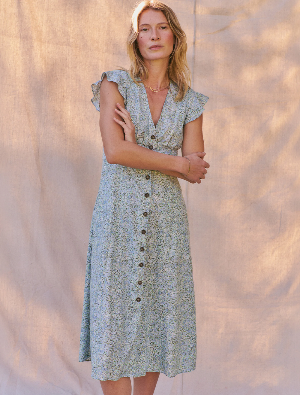 Model wearing Marine Layer's camila midi dress in cool floral dress.