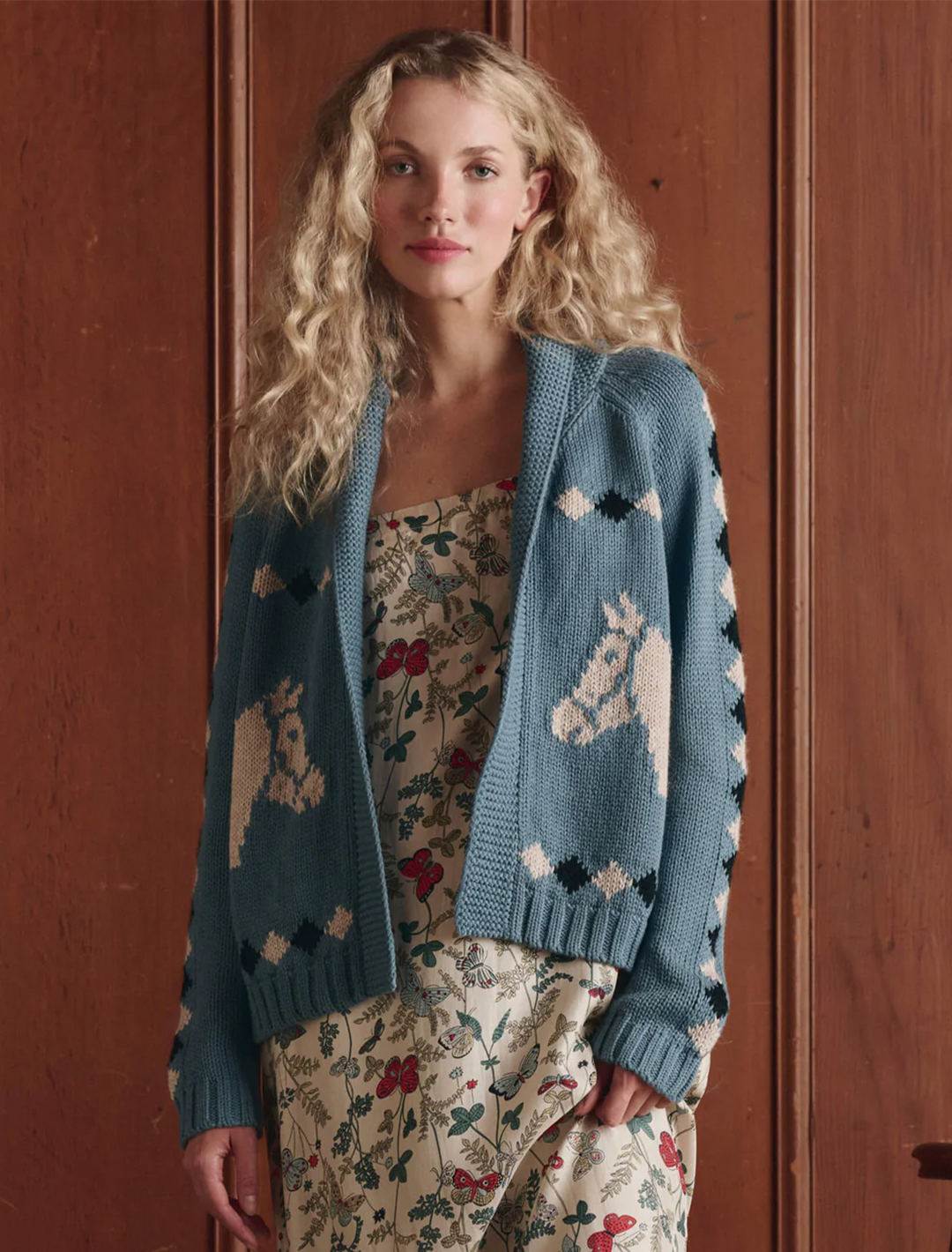 Model wearing The Great's the stable lodge cardigan in blue bell.