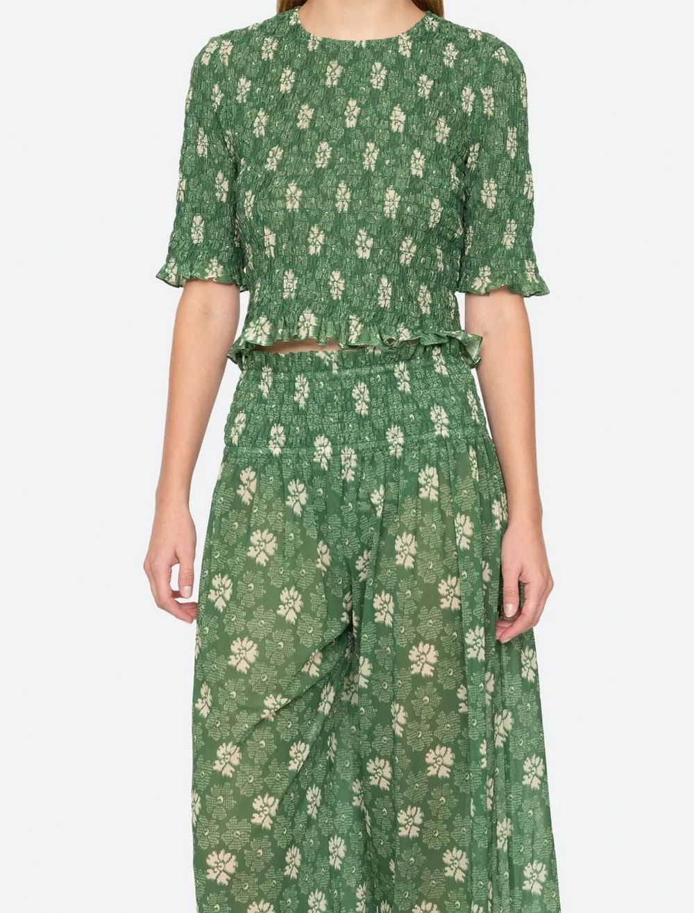 Model wearing Sea NY's gloria print top in green.