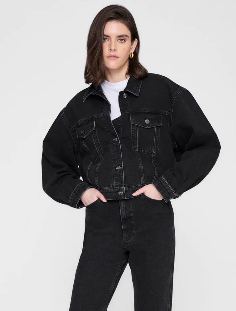 Model wearing Anine Bing's quincy denim jacket in vintage black.