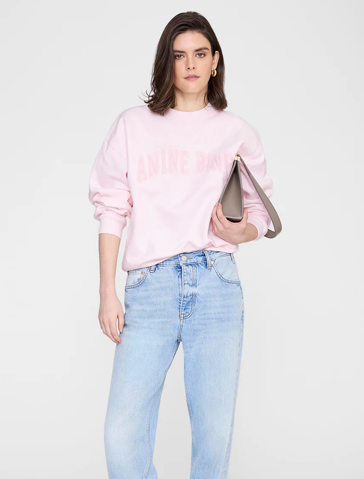 Model wearing Anine Bing's spencer sweatshirt in powder pink.