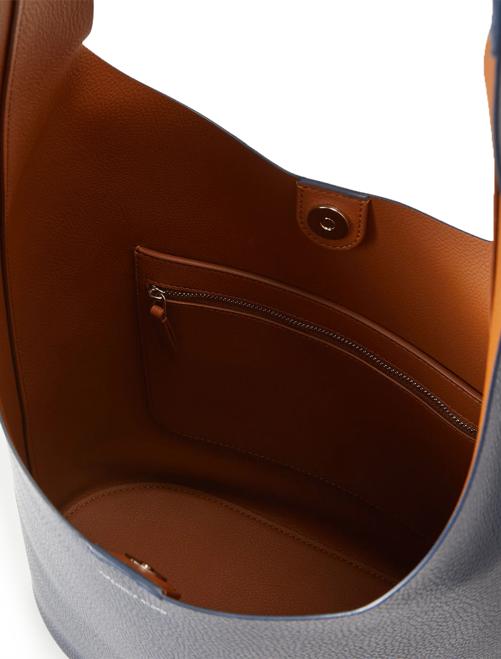 Close-up inside view of Veronica Beard's large loop bag in navy and hazelwood leather.