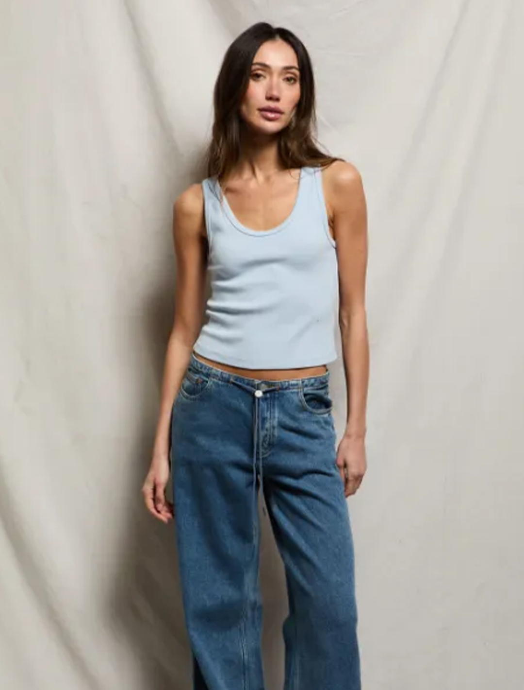 Model wearing Perfectwhitetee's blondie tank in powder blue.