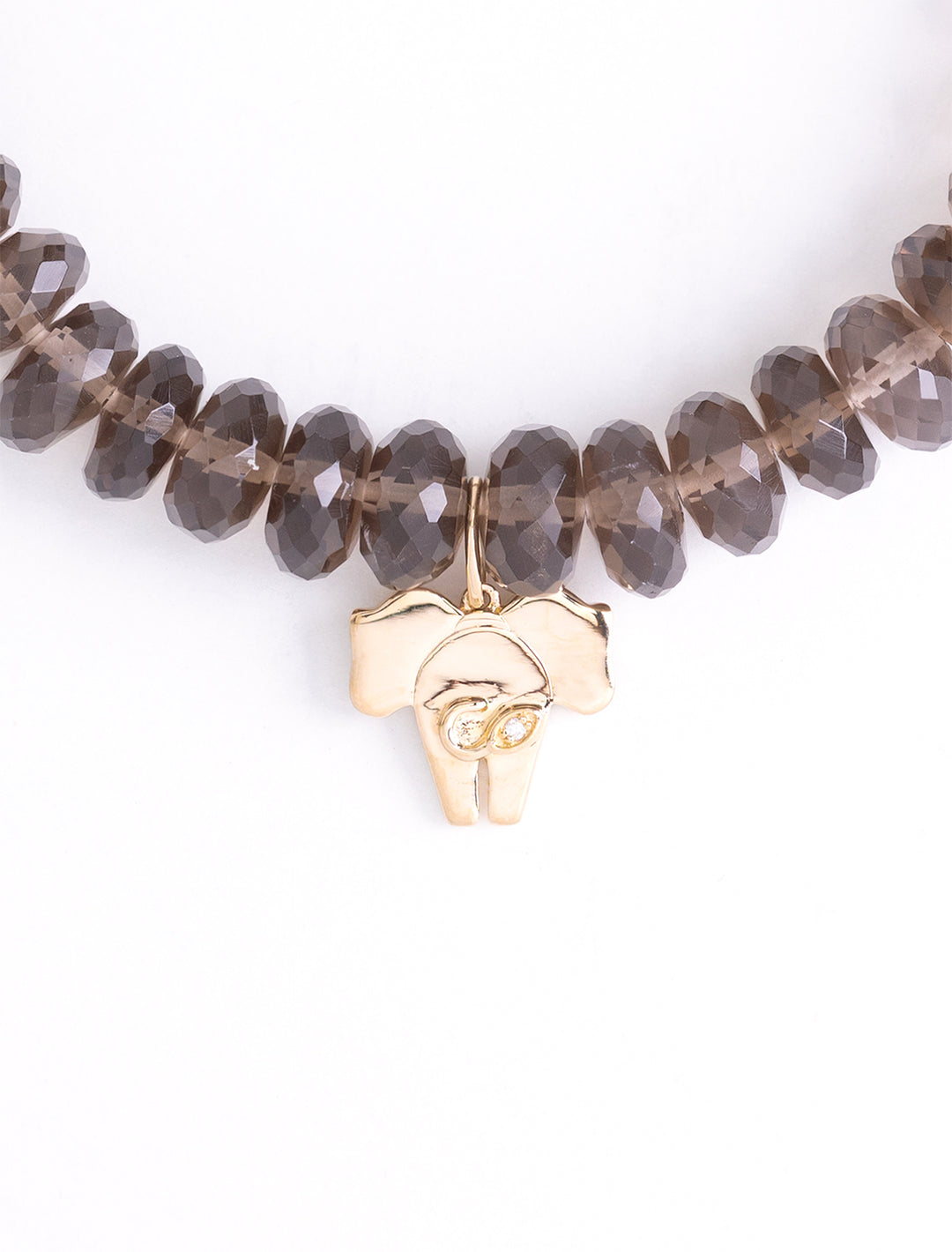 gold elephant tail charm on smokey quartz