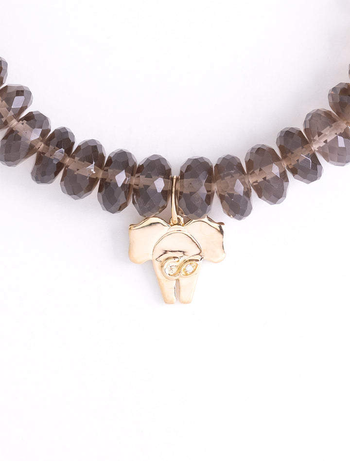 gold elephant tail charm on smokey quartz