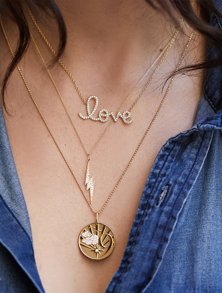 pave diamond and gold lightning bolt charm