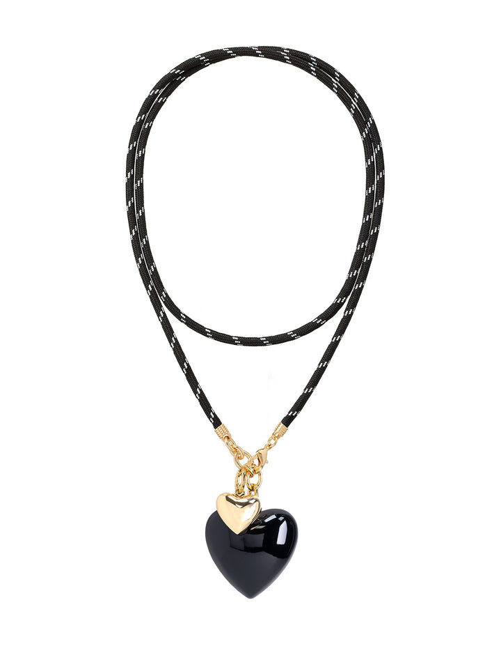 black long cord necklace with large black and small gold hearts