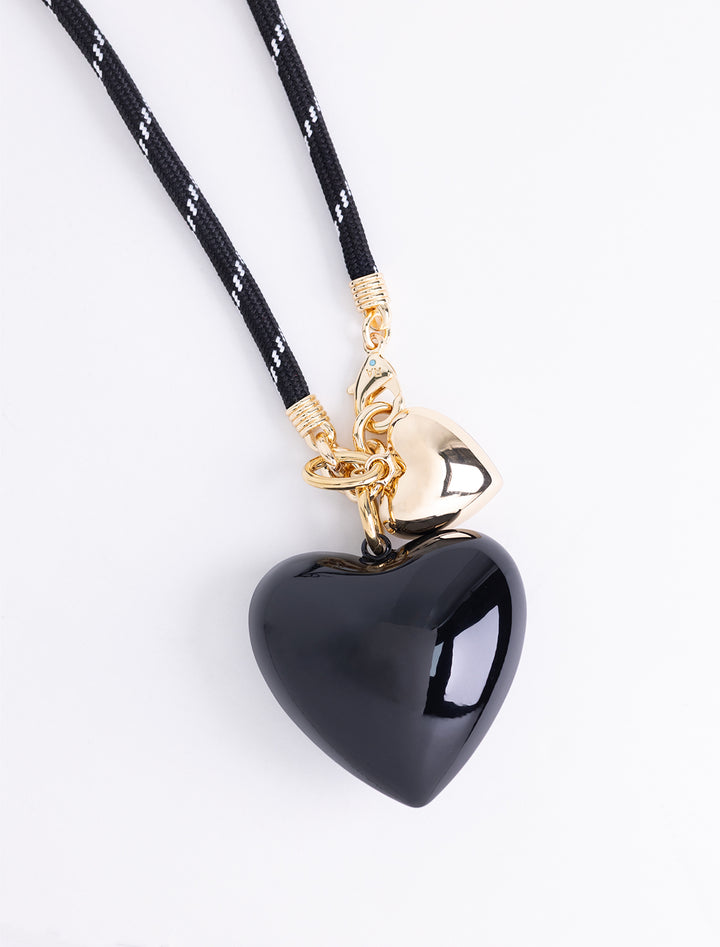 black long cord necklace with large black and small gold hearts