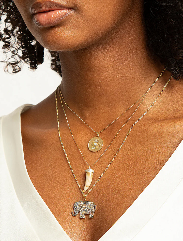 Model wearing Sydney Evan's protective eye coin charm on heavy tiffany.