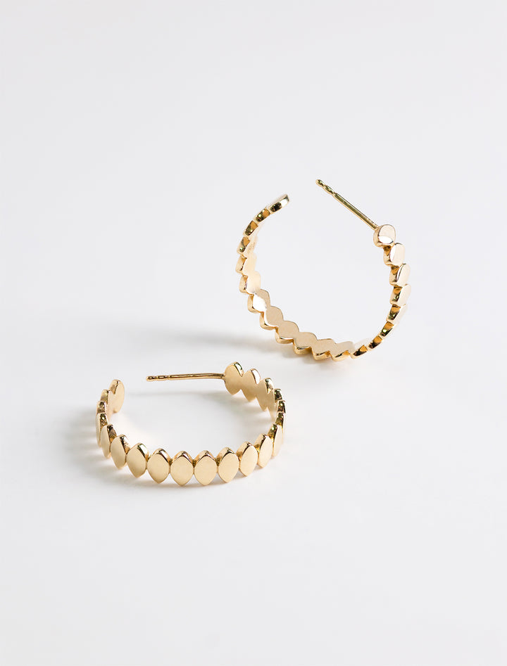 Close-up view of Sydney Evan's pure marquise medium hoops.