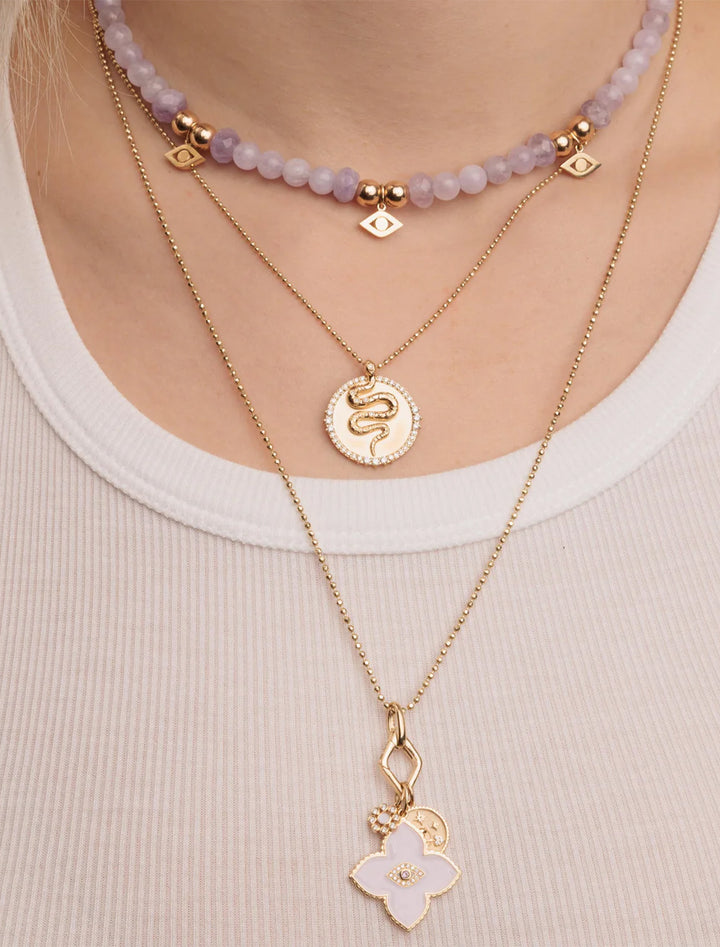 Model wearing Sydney Evan's snake coin charm on heavy bolita.