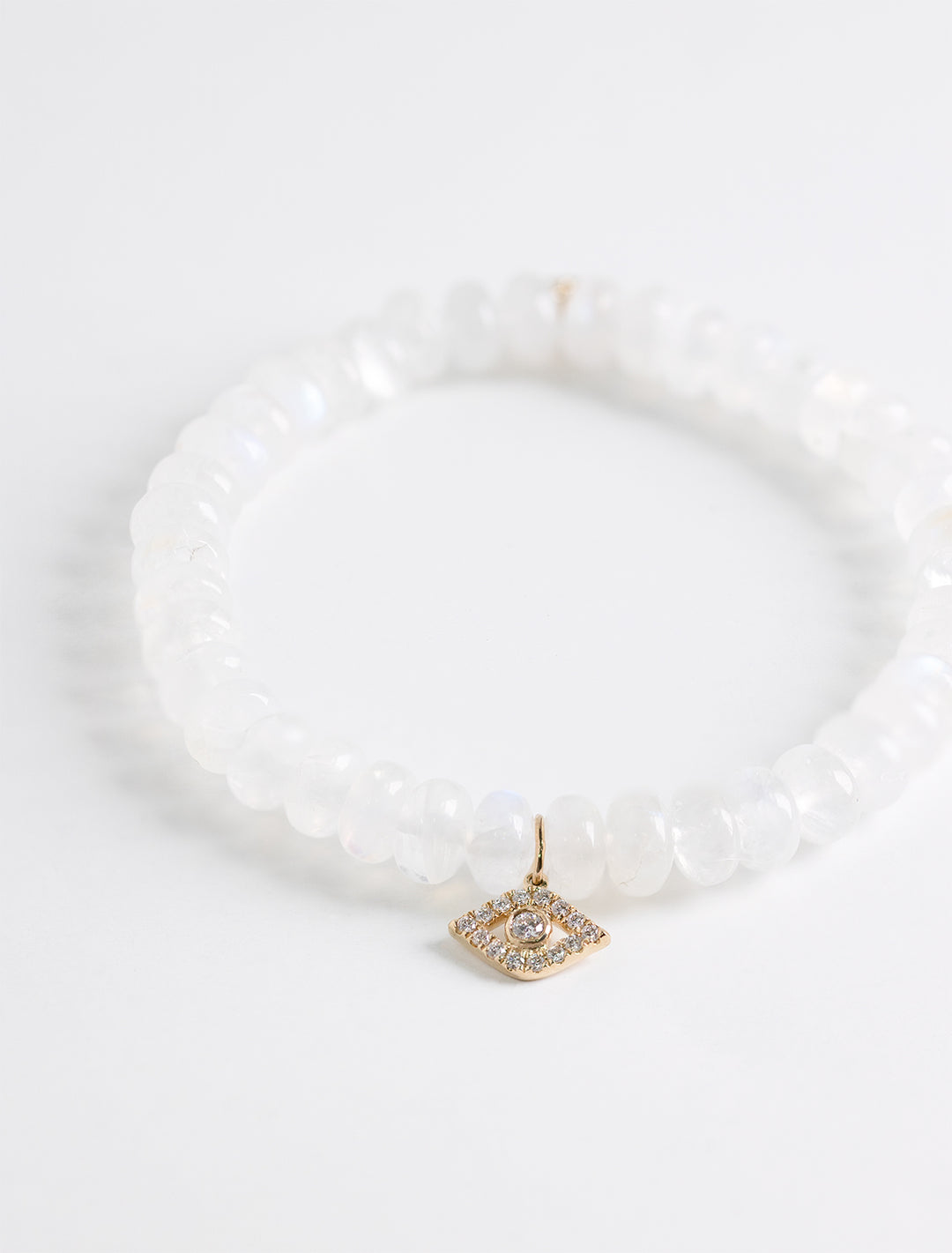 medium bezel protective eye charm on rainbow moonstone smooth rondelle