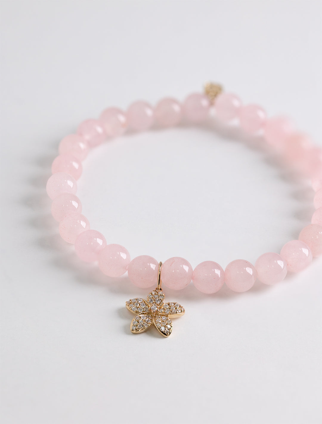 plumeria charm on rose quartz