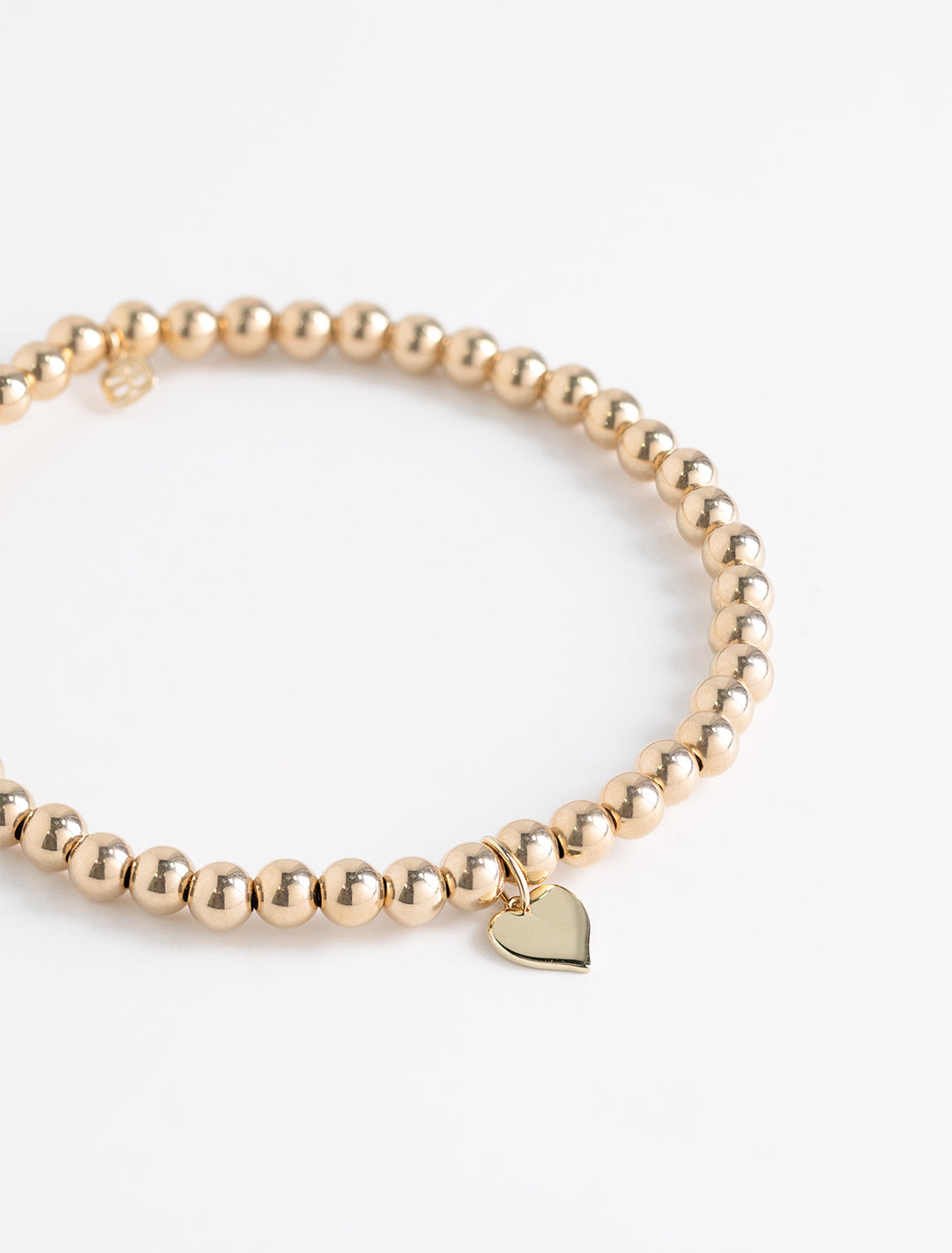 4mm tiny pure heart charm on 14k gold