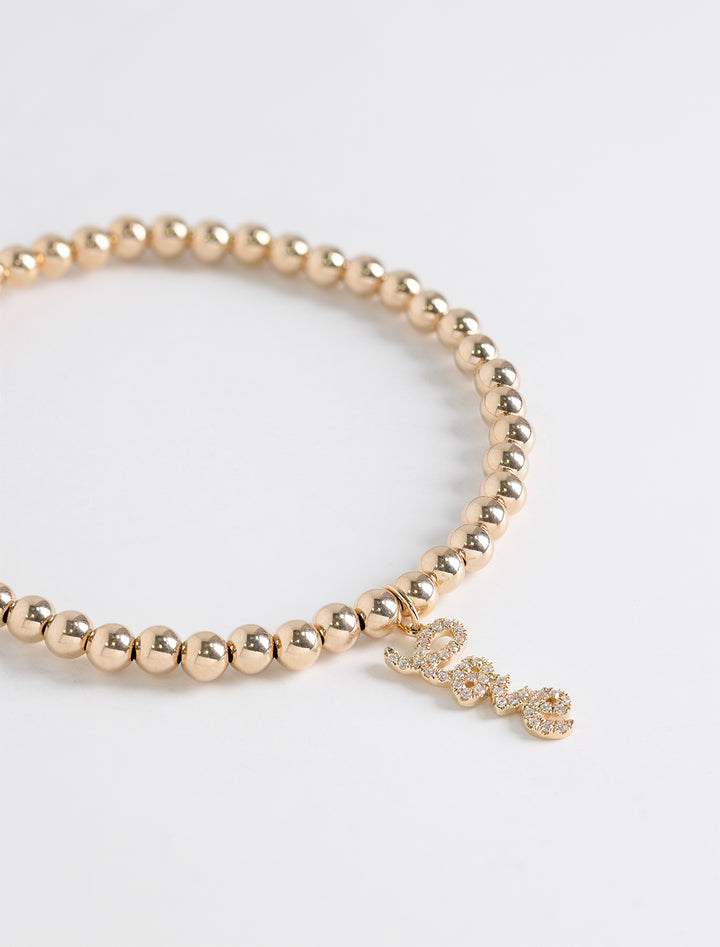 4mm mini pave "love" script charm on 14k gold