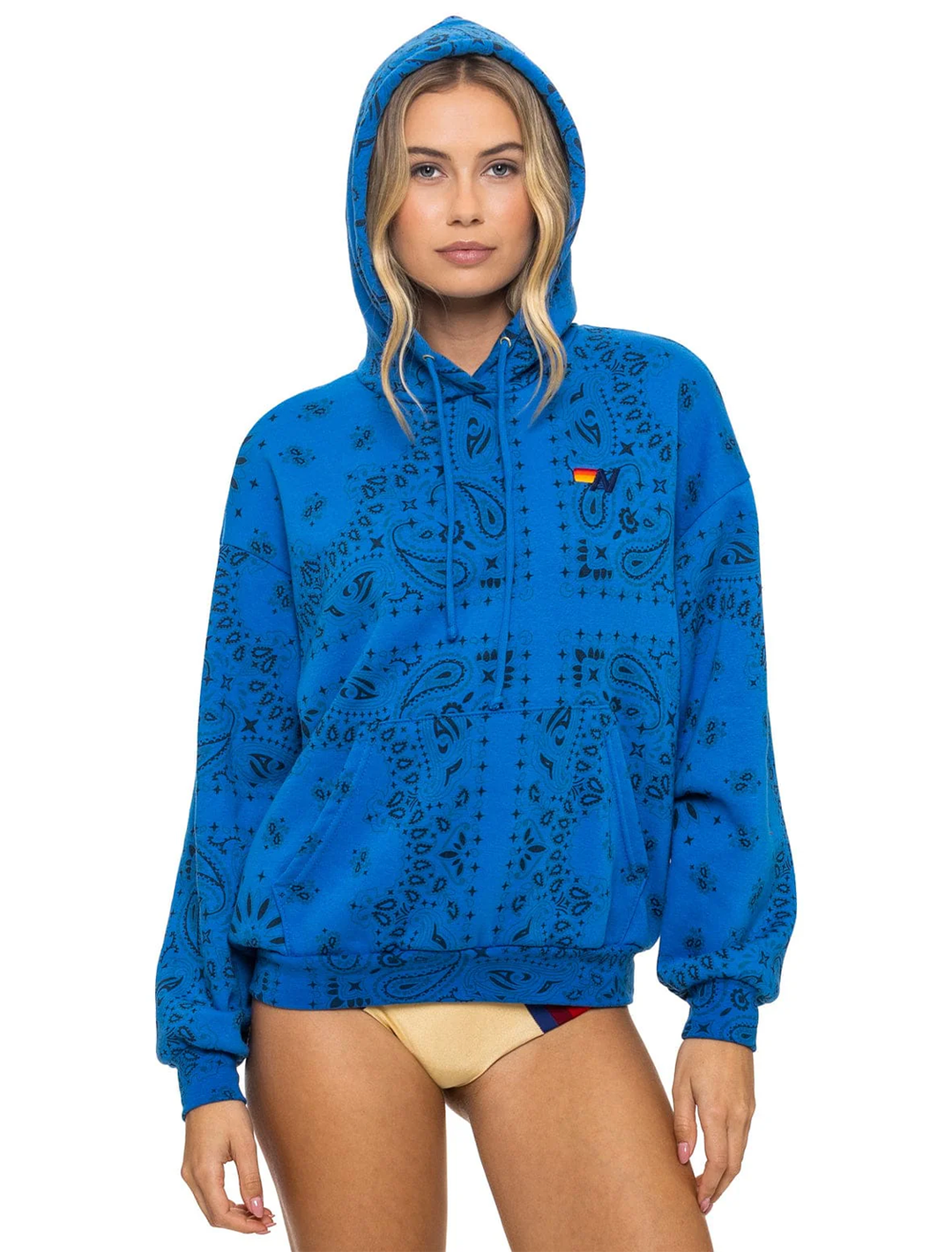 Model wearing Aviator Nation's bandana relaxed pullover hoodie in adventure blue.