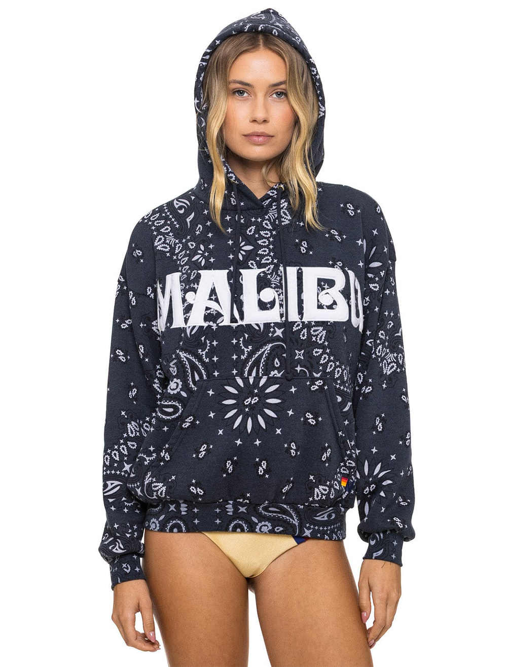 Model wearing Aviator Nation's malibu bandana relaxed pullover hoodie in charcoal.