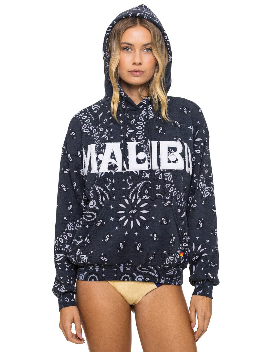 Model wearing Aviator Nation's malibu bandana relaxed pullover hoodie in charcoal.