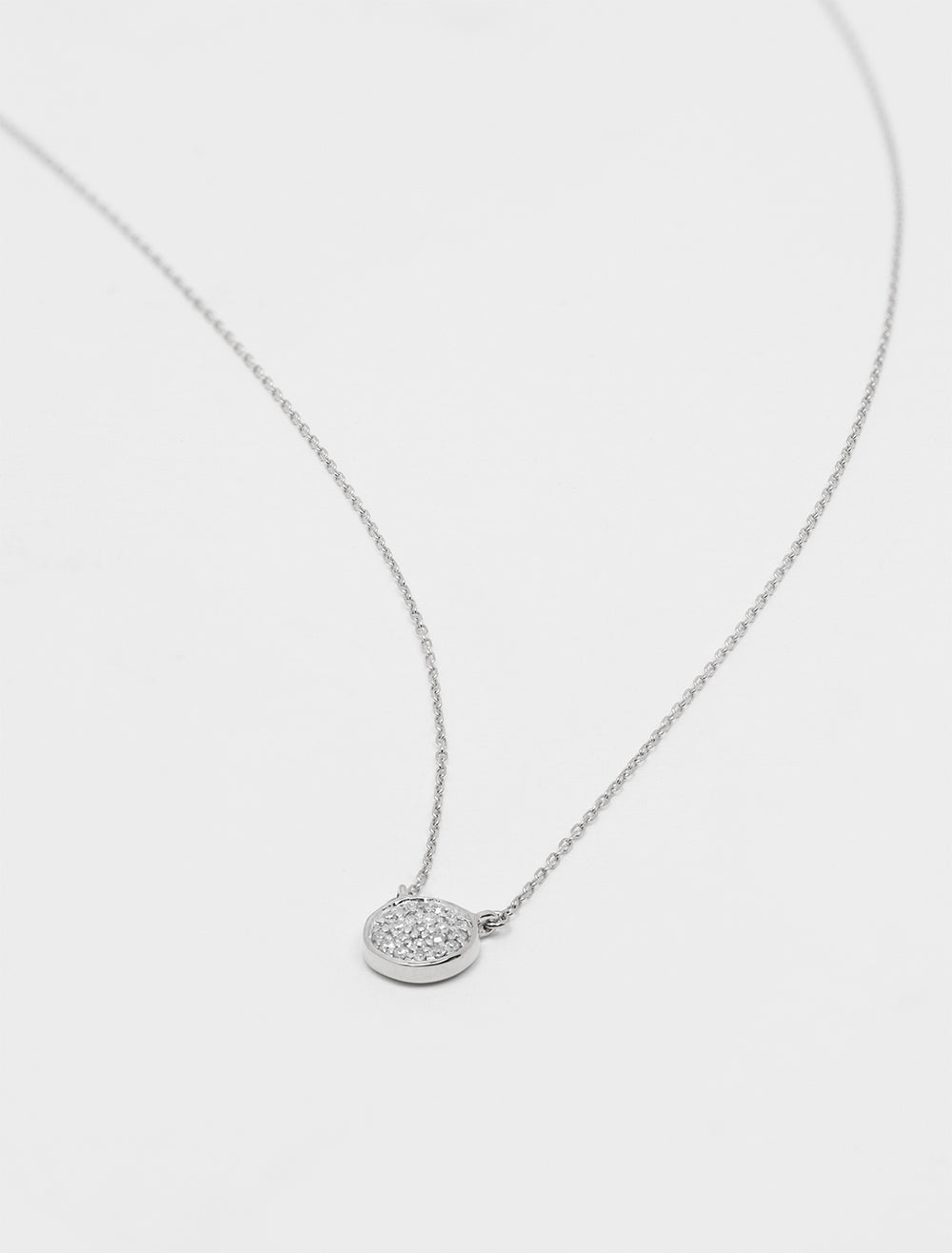 Laydown of Adina Reyter's solid pave disc necklace in silver.