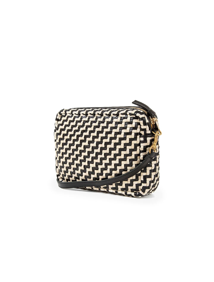 Side angle view of Clare V.'s woven midi sac in black and cream zig zag.