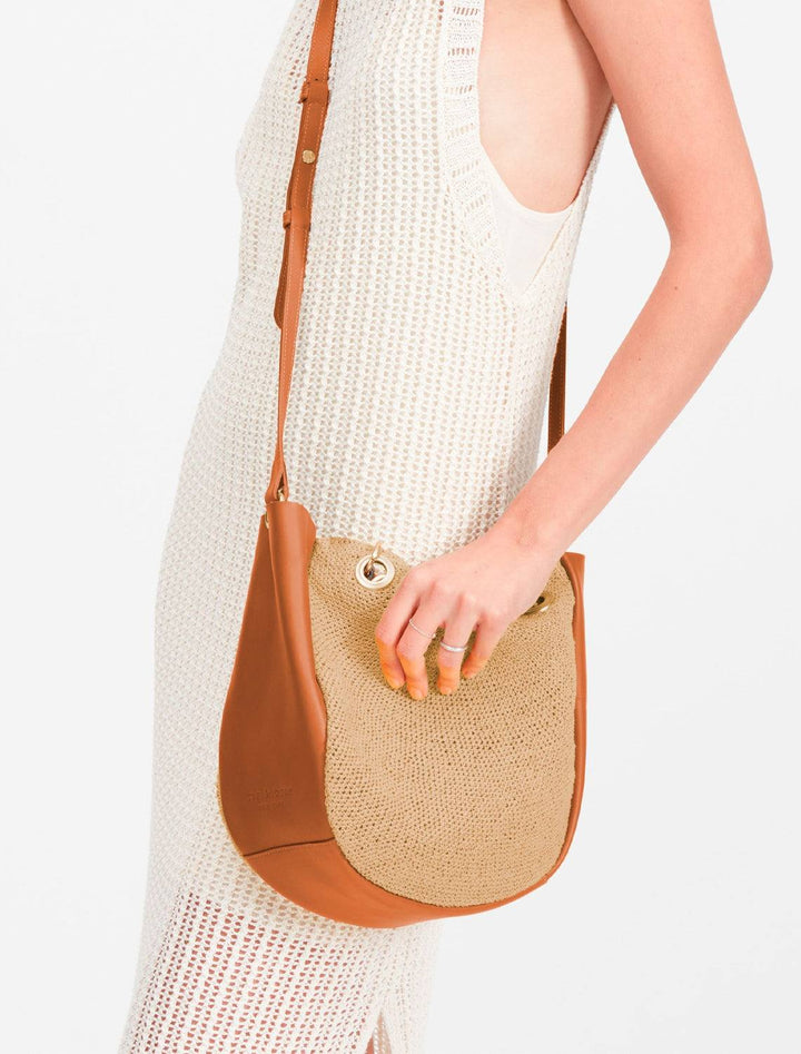 model with the revival summer mini tote hanging from crossbody strap