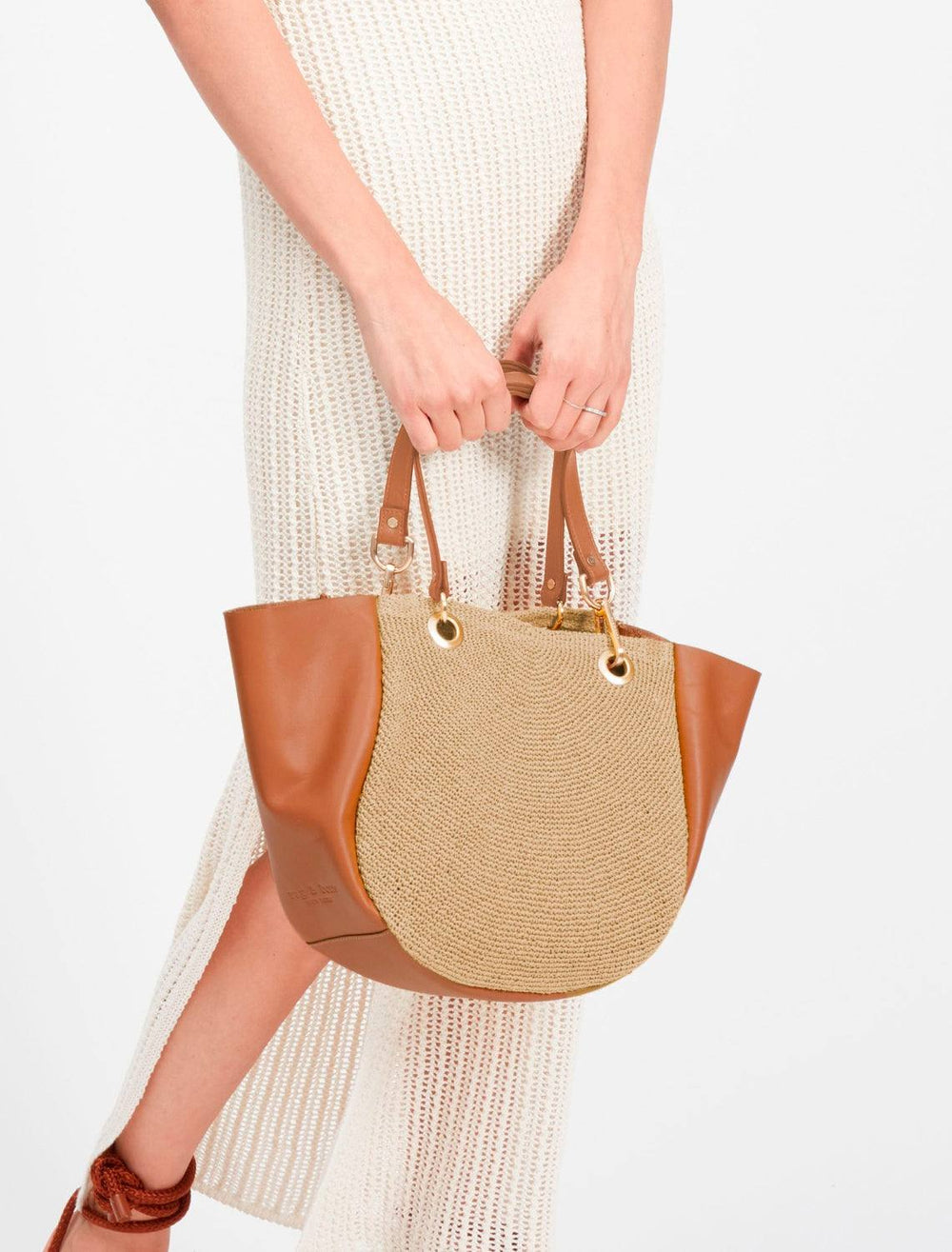 model carrying the revival summer mini tote by the handles