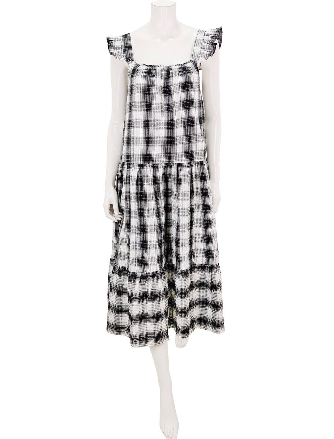 front view of prairie life dress featuring a square neckline, midi length, ruffled cap sleeves, and a three tiered construction