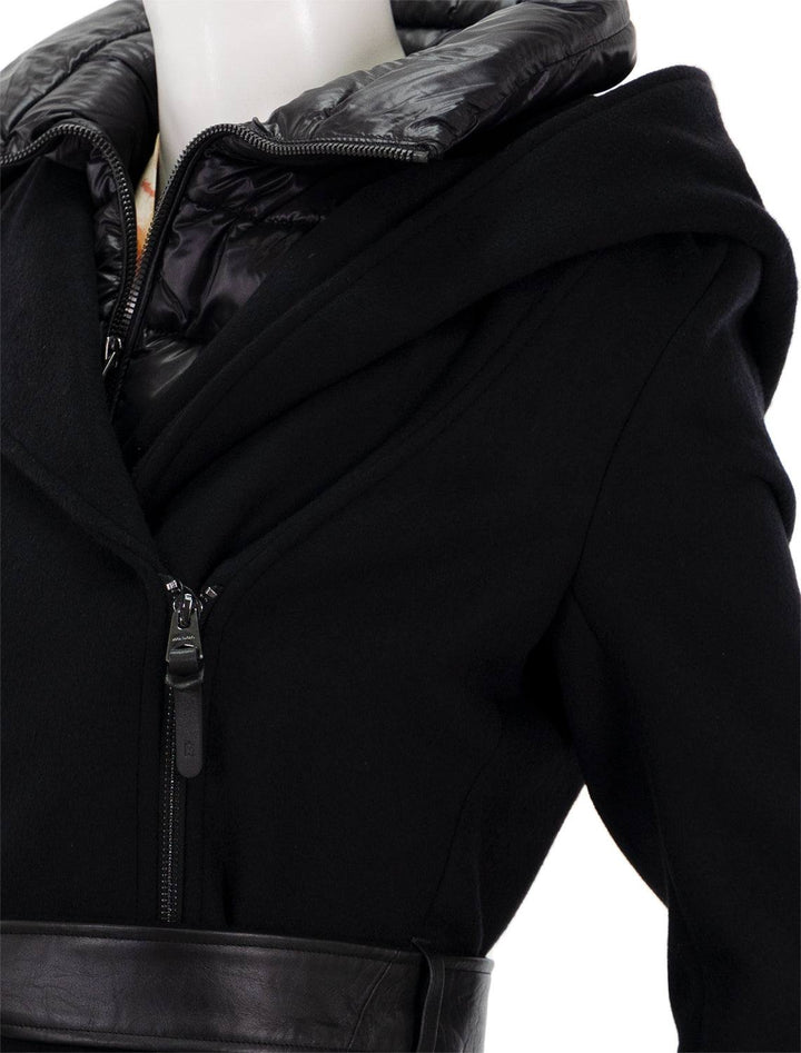 close up view of shia coat in black with leather trim asymmetrical zipper