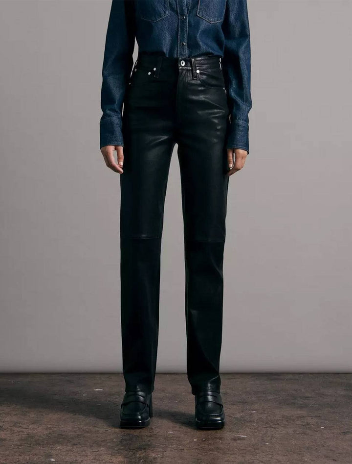 model wearing vintage leather cigarette pant in black with a denim shirt and black loafers 