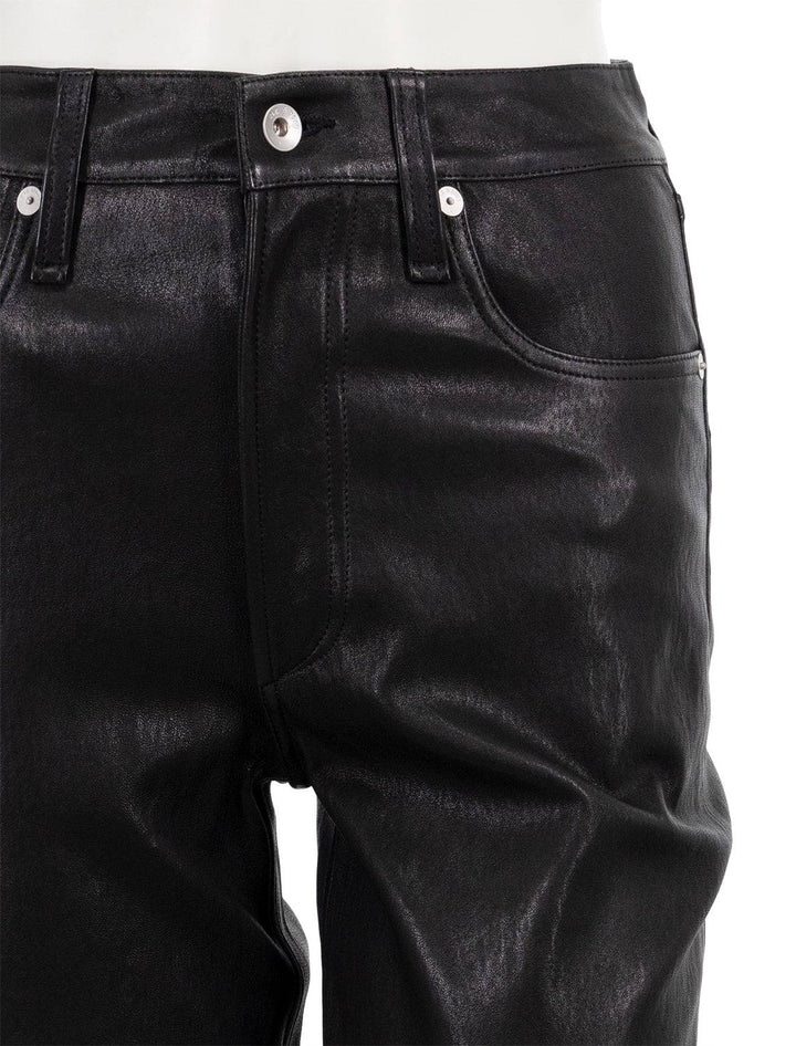 close up view of vintage leather cigarette pant in black zip-button closure