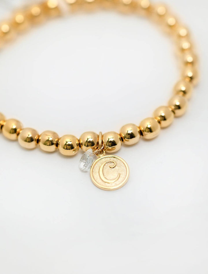 close up view of beaded monogram bracelet | C charm and gem