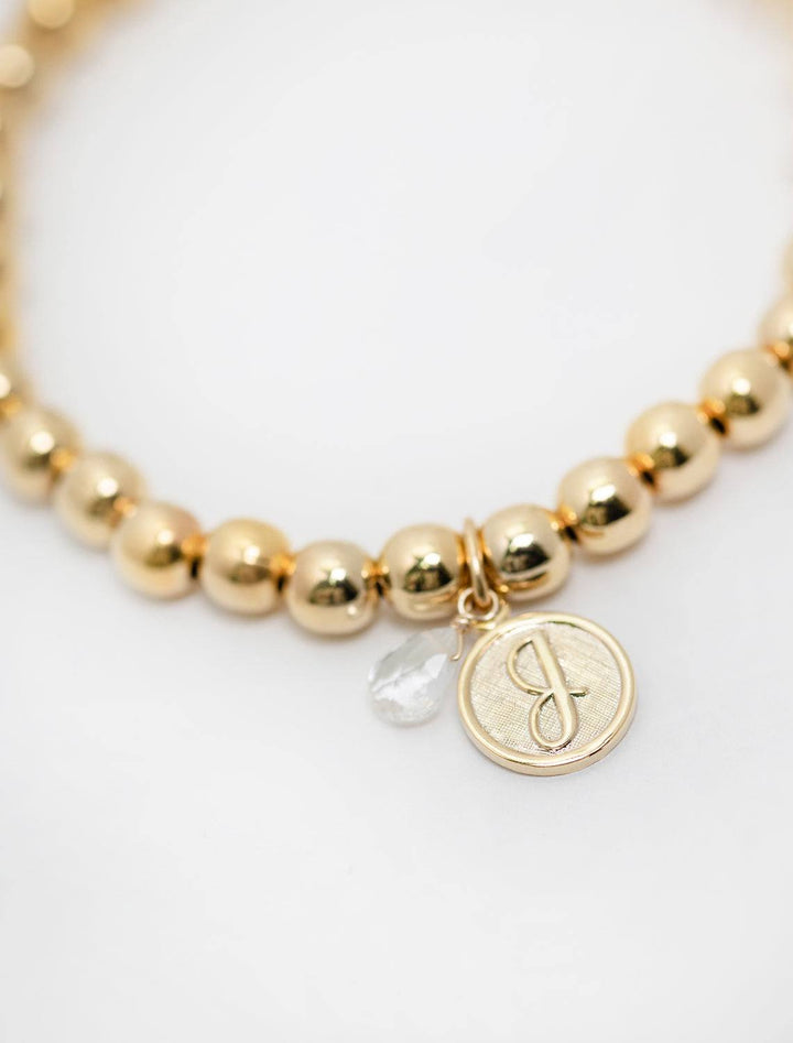 close up view of beaded monogram bracelet | J charm and gem