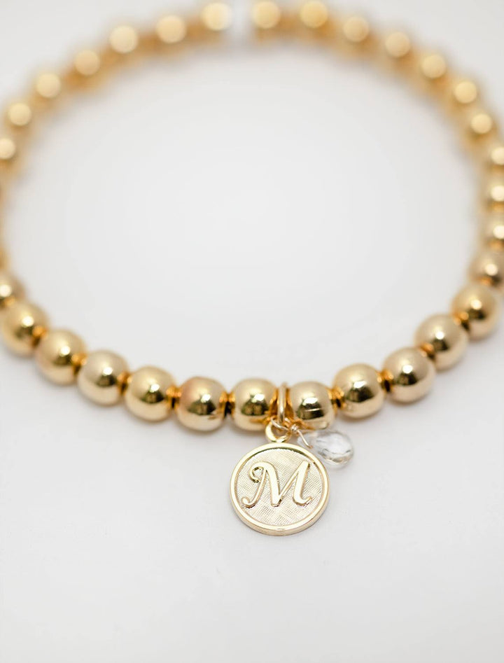 close up view of beaded monogram bracelet | M charm and gem