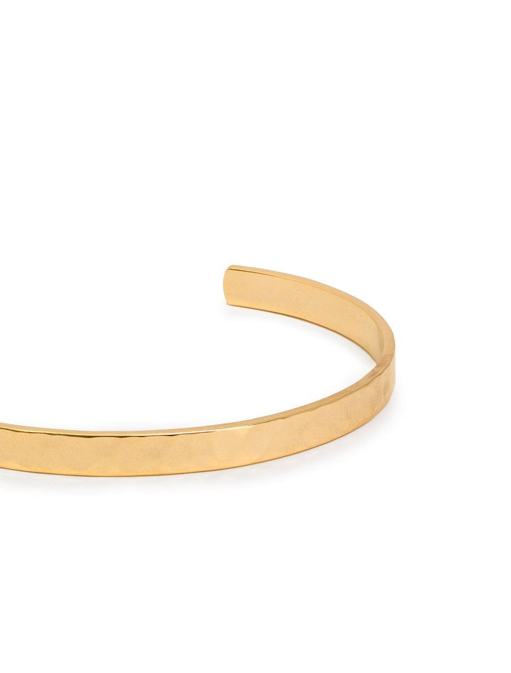 Close-up detailed view of one gold hammered cuff. Shows hammered and matte detail.