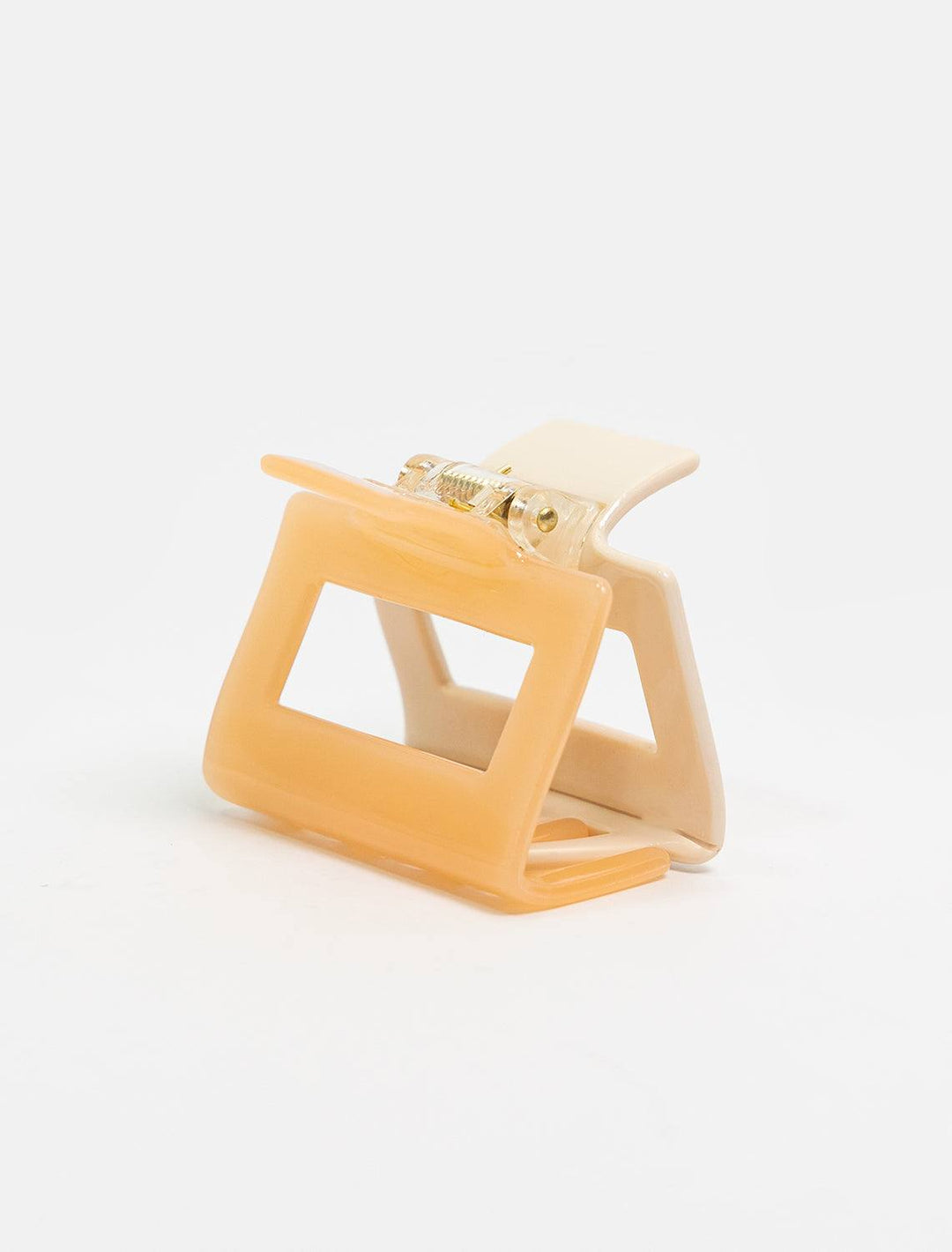 detailed view of two tone claw. shows one side of claw is peach and one is a light beige.