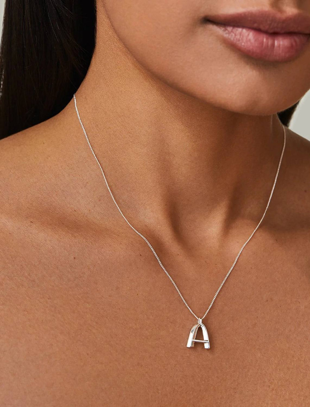 model wearing monogram necklace in silver | A