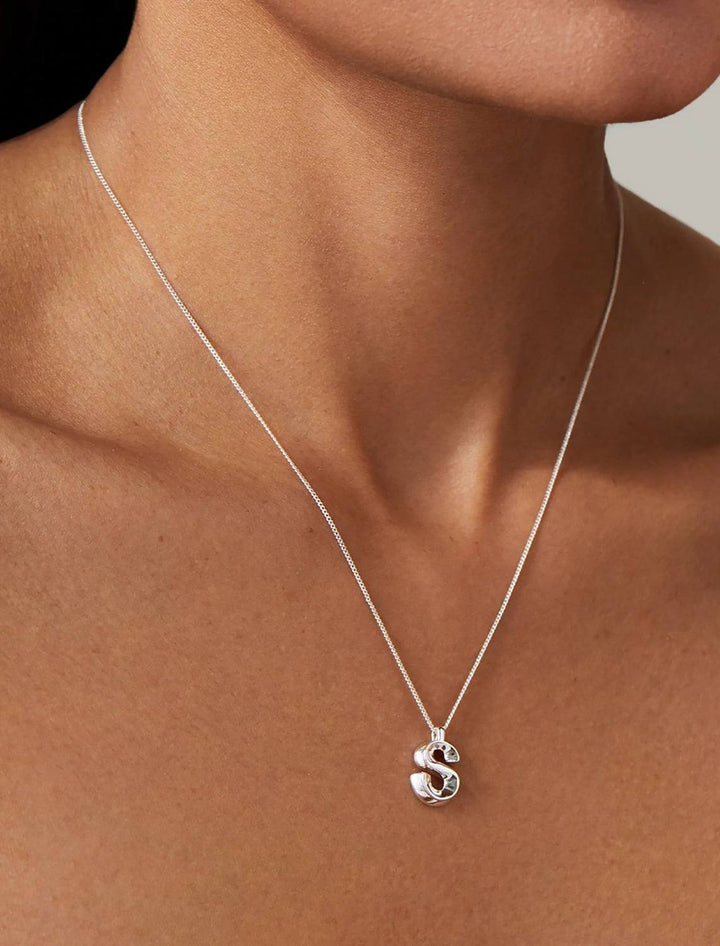 model wearing monogram necklace in silver | S