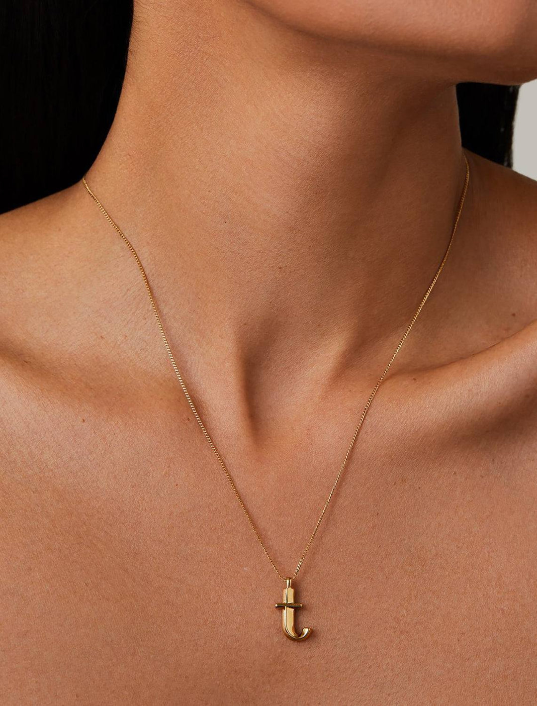 model wearing monogram necklace in gold | T