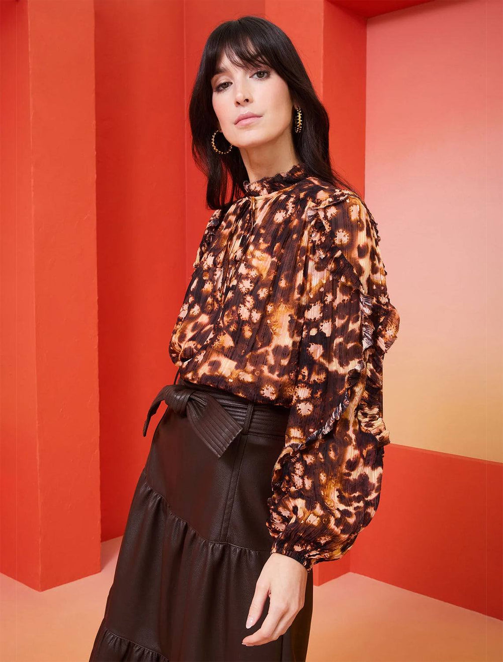 model wearing haley blouse in amber speckle with brown leather skirt 